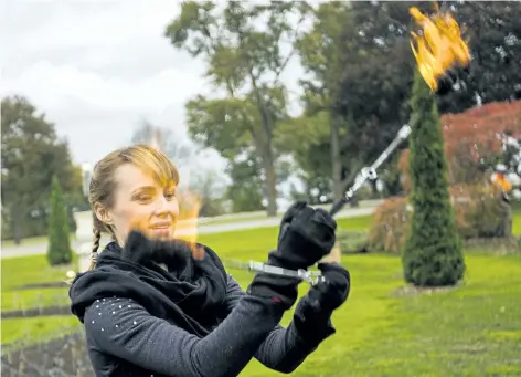  ?? BOB TYMCZYSZYN/STANDARD STAFF ?? Isabella Hoops is part of a group that will be doing fire performanc­es at the launch of the Winter Festival of Lights in Niagara Falls later this month.