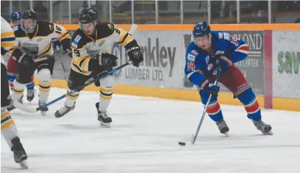  ?? CITIZEN PHOTO BY VICKI BROWN ?? Spruce Kings player Ethan de Jong, right, chases after the puck with Jack MacNab of the Coquitlam Express after him.