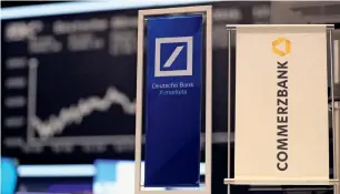  ?? — Reuters ?? Banners of Deutsche Bank and Commerzban­k are displayed in front of the German share price index, DAX board, at the stock exchange in Frankfurt, Germany.