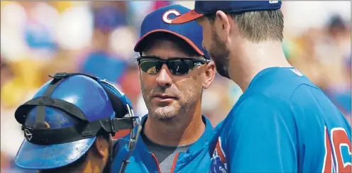  ?? | MARK DUNCAN~AP ?? Cubs manager Dale Sveum (center) says it’s no longer easy to find quality free agents worthy of long-term contracts because teams are locking them up.