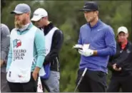  ?? TOM REEL — THE SAN ANTONIO EXPRESS-NEWS VIA AP ?? Kevin Chappell studies the map of the 9th with his caddy as a stiff wind blows against them during the third round of the Valero Texas Open at TPC San Antonio Oaks Course.