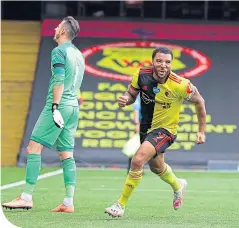  ??  ?? Troy Deeney turns away after scoring his second penalty