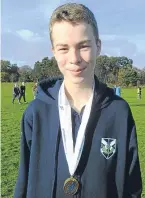  ??  ?? Ben Sandilands with his medal after winning the U15s boys 2km.