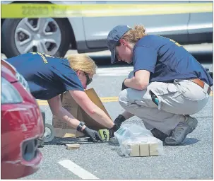  ?? AP PHOTO ?? FBI Evidence Response Team members mark evidence at the scene of a multiple shooting in Alexandria, Va., Wednesday involving House Majority Whip Steve Scalise of La., and others during a congressio­nal baseball practice.