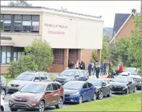  ?? GLEN WHIFFEN/THE TELEGRAM ?? Parents wait outside Prince of Wales Collegiate in St. John’s Wednesday to pick up their children. The school went into secure mode after an incident in which several students were hit with bear spray.