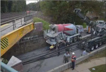  ?? PETE BANNAN – DIGITAL FIRST MEDIA ?? This mixer truck slammed into the Amtrak bridge over King of Prussia Road in Radnor, closing the road Thursday.