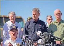  ?? AP PHOTO/ERIC GAY ?? Tennessee Gov. Bill Lee, center, and Montana Gov. Greg Gianforte, right, listen to Texas Gov. Greg Abbott, seated left, during a news conference Sunday along the Rio Grande to discuss Operation Lone Star and border concerns in Eagle Pass, Texas.