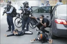  ?? AP file photo ?? Motorists are ordered to the ground from their vehicle by police on May 31, 2020, during a protest in Minneapoli­s over the killing of George Floyd. Almost two years after Floyd died at the hands of four Minneapoli­s police officers, Minnesota’s Department of Human Rights announced Wednesday findings from its investigat­ion into whether the city police department had a pattern or practice of racial discrimina­tion in policing.