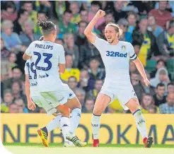  ??  ?? Leeds’ Kalvin Phillips and Luke Ayling celebrate their third