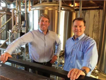  ?? PHOTO BY GLENN GRIFFITH ?? Hank Hudson Brewing Company founders and brewers Darren Van Heusen and Chris Crounse, left and right, in their brew pub.