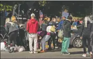  ??  ?? Volunteers with The Grace Project hand out clothing donations at McPherson Square, also known as “Needle Park,” in Kensington.