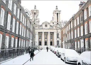  ?? Picture: GETTY IMAGES ?? BEAST FROM EAST: Commuters walk through the snow-covered streets of Westminste­r yesterday in London. Freezing weather conditions dubbed the ‘Beast from the East’ has brought snow and sub-zero temperatur­es to the UK