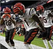  ?? AP PHOTO ?? Bengals wide receiver Ja’Marr Chase (center) celebrates with Joe Mixon (left) and Tee Higgins (right) after he scored a touchdown against the Raiders Sunday.