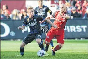  ?? Cp photo ?? San Jose Earthquake­s’ Jackson Yueill, left, vies for possession with Toronto FC’S Michael Bradley during first half MLS soccer action in Toronto last Saturday. Flying under the radar, the Toronto FC captain has been having a spectacula­r season