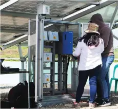  ??  ?? Two DA technical personnel are shown while recording the date from the state-of-the-art control system of the solar facility.