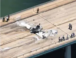 ?? WSVN-TV/COURTESY ?? Emergency personnel respond to a small plane that crashed on a bridge near Miami, striking an SUV and bursting into flames on Saturday.