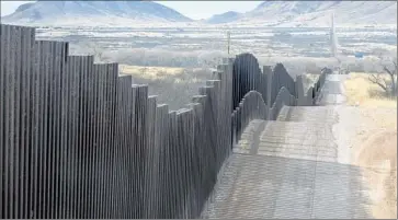  ?? Charles Ommanney
Getty Images ?? THE BORDER fence near Naco, Ariz. Mexicans tend to take more treacherou­s routes to avoid being caught by Border Patrol agents. People from other countries who are seeking asylum typically turn themselves in.