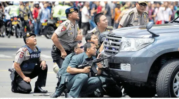  ??  ?? Indonesisc­he Polizeiein­heiten gehen im Zentrum von Jakarta in Stellung – stundenlan­g lieferten sie sich Gefechte mit den verschanzt­en Terroriste­n