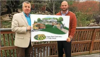  ?? GARY PULEO ?? Elmwood Park Zoo Public Affairs Director Stan Huskey, left, and Executive Director Al Zone with the blueprint for Castner House and Conservato­ry.