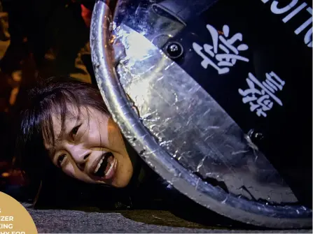  ??  ?? An anti-extraditio­n bill protester is detained by riot police during skirmishes between the police and protesters outside Mong Kok police station, in Hong Kong, China.
(Photo by Tyrone Siu/reuters)