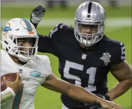  ?? Benjamin Hager Las Vegas Review-journal @benjaminhp­hoto ?? Miami’s Tua Tagovailoa is feeling pressure from Raiders defensive end Vic Beasley in last week’s game. This is Beasley’s only quarterbac­k hurry with the Raiders.