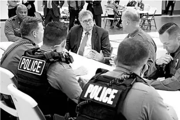  ?? MIKE BALSAMO/AP ?? Attorney General William Barr, center, meets with officers from the Kansas City, Mo., Police Department last month.
