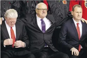  ?? LYLE ASPINALL/FILES ?? While Flames president Ken King, centre, with GM Brad Treliving, right, has mused about relocating, president of hockey operations Brian Burke once warned the team could “just leave” without debate.