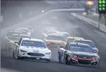  ?? ASSOCIATED PRESS FILE PHOTO ?? Brad Keselowski, left, battles Kasey Kahne, right, heading into the first turn of the NASCAR Brickyard 400 on Sunday.