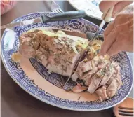  ?? CHRIS KOHLEY, MILWAUKEE JOURNAL SENTINEL ?? Bob Orvis of Glendale slices his roast pork tenderloin. Bob Orvis recently prepared this hearty pork dish, with sides of glazed carrots and braised red cabbage, for his family of four. The carrot recipe is on page 5E.