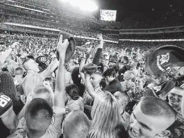  ?? Sam Craft / Associated Press ?? Texas A&M students flood Kyle Field after the Aggies upset No. 1 Alabama on Saturday night. The win lifted the unranked Aggies to No. 21 in the AP poll.