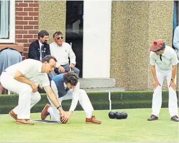  ??  ?? A helping hand for a competitor in the Scottish Bowling for the Blind competitio­n.