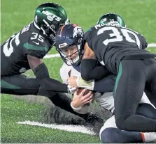  ?? Elsa, Getty Images ?? Denver’s Jeff Driskel slides and is hit by Bradley McDougald, right, and Pierre Desir of the New York Jets.