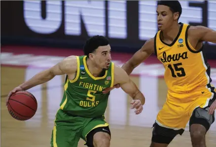  ?? PAUL SANCYA - THE ASSOCIATED PRESS ?? Oregon guard Chris Duarte (5) drives on Iowa forward Keegan Murray (15) during the second half of a men’s college basketball game in the second round of the NCAA tournament at Bankers Life Fieldhouse in Indianapol­is, Monday, March 22, 2021.