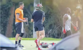  ?? CHRIS URSO/TNS ?? Tom Brady, left, and several of his new teammates worked out on a high school field in Tampa, Fla., earlier this week.