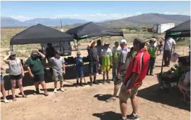  ??  ?? Heads or Tails: Wasatch Wing & Clay coach Kirk Horinek lead the athletes in a game to determine who wins a shotgun during an awards ceremony on June 3, 2018.