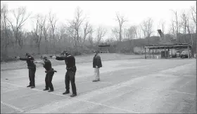  ?? NWA Democrat-Gazette/ANDY SHUPE ?? Instructor Terry Tate (right) gives commands Thursday as officers Andy Nunez (from left), Clarisa Navarro and Cpl. Aaron Tomlinson of the Fayettevil­le Police Department train at the department’s gun range in south Fayettevil­le. About $35 million for a new police headquarte­rs and $3 million in improvemen­ts to public buildings is included in a bond referendum Fayettevil­le voters will consider April 9.