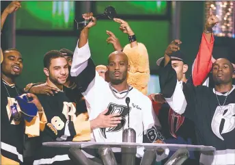  ?? AP PHOTO LAURA RAUCH, FILE ?? DMX, center, accepts the R&B Album Artist of the Year during the 1999 Billboard Music Awards in Las Vegas, on Dec. 8, 1999. The family of rapper DMX says he has died at age 50 after a career in which he delivered iconic hip-hop songs such as “Ruff Ryders’ Anthem.” A statement from the family says the Grammy-nominated rapper died at a hospital in White Plains, New York, “with his family by his side” after being placed on life support for the past few days. He was rushed to a New York hospital from his home April 2.