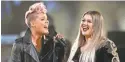  ?? MATT SAYLES/INVISION/AP ?? Pink, left, and Kelly Clarkson honor first responders.