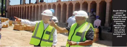  ??  ?? South Mining general manager Mr Chenji Li leads Industry and Commerce Deputy Minister Raj Modi on a tour of the company’s battery oven plant