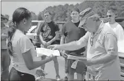  ?? Spencer Lahr / Rome News-Tribune ?? Woodrow Gaines (right) hands Aleeyah Blanchard a certificat­e of completion Saturday at Richard B. Russell Regional Airport.