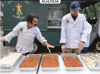  ?? NATHAN KEAY/ MCA CHICAGO ?? During an October 1 activation of Enemy Kitchen outside the MCA, Michael Rakowitz ( left) serves Iraqi cuisine with the help of U. S. military veterans.