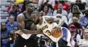  ?? GERALD HERBERT / AP ?? Los Angeles Lakers forward Lebron James drives to the basket against New Orleans Pelicans forward Zion Williamson Sunday.