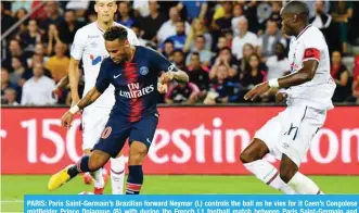  ?? — AFP ?? PARIS: Paris Saint-Germain’s Brazilian forward Neymar (L) controls the ball as he vies for it Caen’s Congolese midfielder Prince Oniangue (R) with during the French L1 football match between Paris Saint-Germain and Caen on Sunday at the Parc des Princes, in Paris.