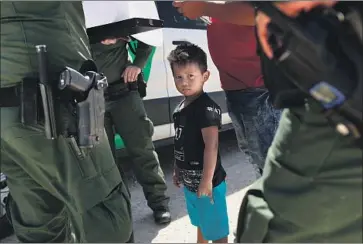  ?? John Moore Getty Images ?? THE SAME AGENCY that takes asylum seekers into custody near the U.S.-Mexico border is also conducting initial “credible fear” interviews, reportedly with children as young as 6, and sometimes over the phone.