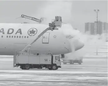  ?? RENÉ JOHNSTON/TORONTO STAR FILE PHOTO ?? An Air Canada plane gets de-iced at Pearson Internatio­nal Airport in January 2014.