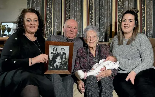  ?? ROBYN EDIE/STUFF ?? Five Generation­s: Joy Rees, 97, centre, holds her great-great-granddaugh­ter Luca Joy Buchanan (one week old), with from left, Rees’s granddaugh­ter, Lynley Macdonald, son Wayne Emmerson and great-granddaugh­ter and Luca’s mother, Olivia Macdonald, sharing the moment in Invercargi­ll on Friday. The photograph held by Lynley is of Joy, one of her sons, her mother, grandmothe­r and great grandfathe­r.