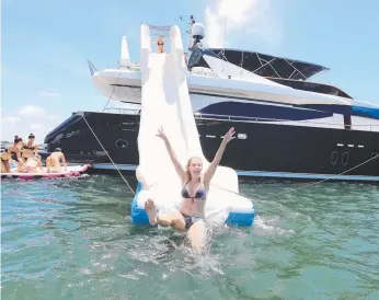  ?? Picture: RICHARD GOSLING ?? Danika Bridge, 30, tests the slide on a luxury yacht.