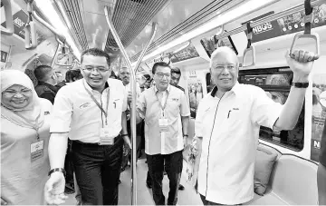  ??  ?? Datuk Seri Najib Tun Razak taking a ride on the MRT Sungai Buloh-Kajang. - Bernama photo