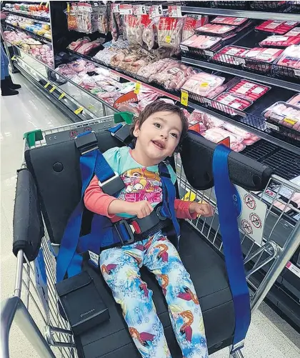  ??  ?? A girl with cerebral palsy in a new Countdown wheelchair designed for those with disabiliti­es.