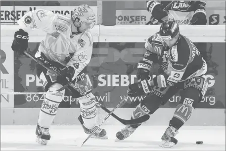  ?? Thomas Oswald/the Associated Press ?? Some NHL stars are still playing despite the ongoing lockout. The New York Islanders’ John Tavares, left, currently playing for Bern, challenges Rapperswil’s Antonio Rizzello for a loose puck during a Swiss First League hockey game in Switzerlan­d on...